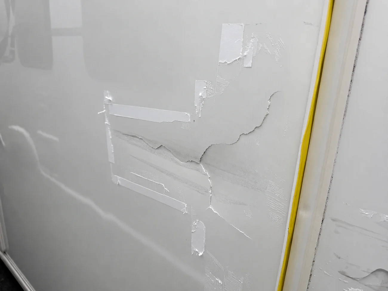 Close-up of cracked and scraped caravan side-panel accident damage ready for specialist assessment